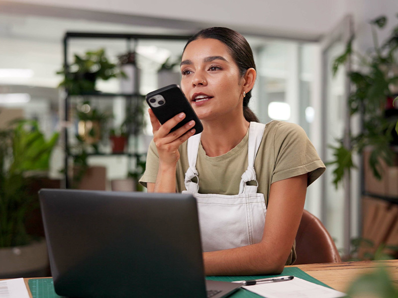 Restaurant owner contacting CTSG support via smartphone at office desk